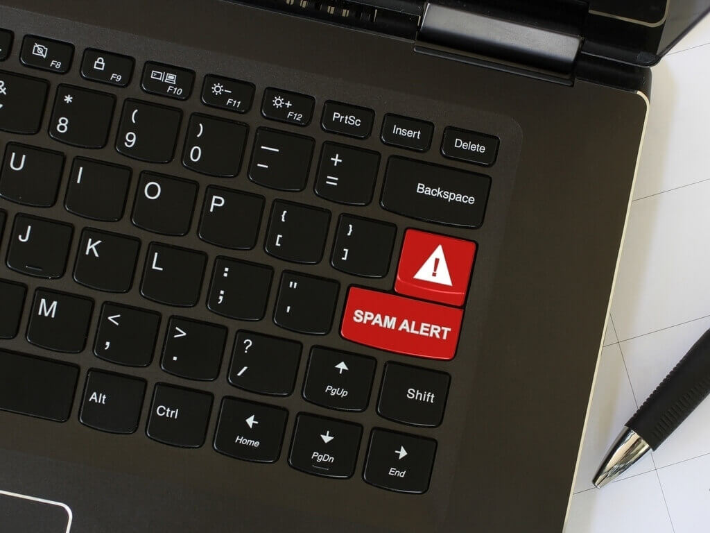 laptop with red spam alert button