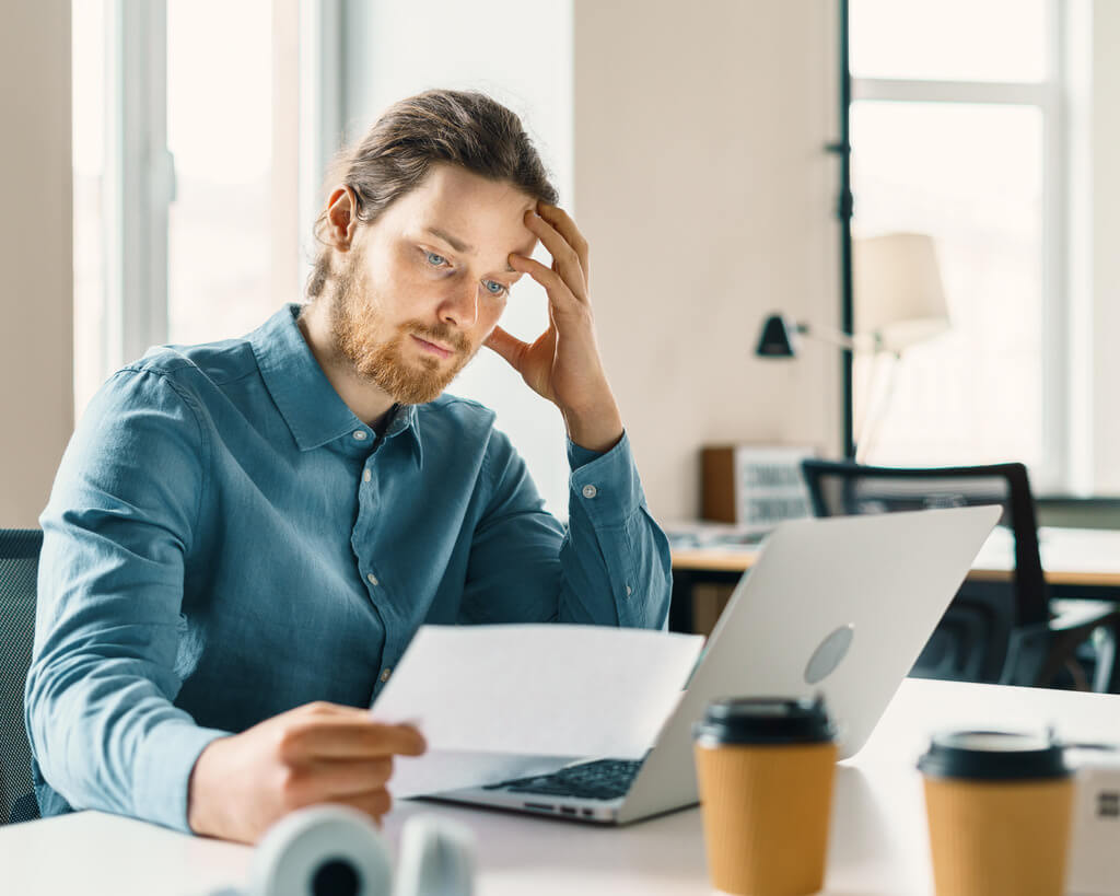 frustrated businessman looking at business report